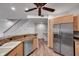Open kitchen with stainless steel appliances and wood-style flooring, blending style and functionality at 11555 Gulf Blvd Blvd # 115, Treasure Island, FL 33706