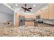 Kitchen with wooden cabinetry, granite countertops, and stainless steel appliances, a chef's dream at 11555 Gulf Blvd Blvd # 115, Treasure Island, FL 33706