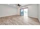 Spacious living room featuring wood floors and sliding glass doors to a balcony at 11555 Gulf Blvd Blvd # 115, Treasure Island, FL 33706