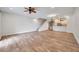 Spacious living room showing hardwood floors, staircase and open to the kitchen area at 11555 Gulf Blvd Blvd # 115, Treasure Island, FL 33706