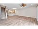 Open-concept living room featuring wood floors and access to the kitchen and staircase at 11555 Gulf Blvd Blvd # 115, Treasure Island, FL 33706