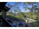 Outdoor wooden deck features bench seating, a central fire pit, and stair access at 1296 Weybridge Ln, Dunedin, FL 34698