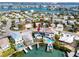 Aerial view of waterfront property with a cozy blue home, private dock, pool, and scenic neighborhood at 14050 W Parsley Dr, Madeira Beach, FL 33708