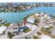 An aerial view of a waterfront property with a cozy blue home, showcasing its prime location and neighborhood at 14050 W Parsley Dr, Madeira Beach, FL 33708