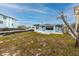 Cozy backyard featuring a quaint blue house with newly installed landscaping at 14050 W Parsley Dr, Madeira Beach, FL 33708