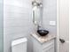 A bathroom with a black vessel sink and granite-look counter top at 14050 W Parsley Dr, Madeira Beach, FL 33708