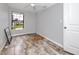 A bedroom with a ceiling fan and wood-look tile flooring has a waterfront view from the window at 14050 W Parsley Dr, Madeira Beach, FL 33708