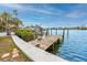 Enjoy waterfront living with a private wooden dock perfect for boating and relaxation at 14050 W Parsley Dr, Madeira Beach, FL 33708