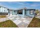Bright light blue home featuring a patio and waterfront views, ideal for serene outdoor living at 14050 W Parsley Dr, Madeira Beach, FL 33708