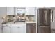 Updated kitchen featuring stone countertops, stainless steel appliances, and tile backsplash at 14050 W Parsley Dr, Madeira Beach, FL 33708