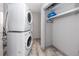 Laundry room with stacked washer and dryer and closet with shelving at 14050 W Parsley Dr, Madeira Beach, FL 33708