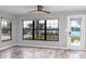 Living room featuring views of the backyard pool, canal, and dock at 14050 W Parsley Dr, Madeira Beach, FL 33708