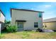 This home's rear facade includes a sliding glass door and a functional yard space at 14430 English Lavender Dr, Wimauma, FL 33598