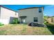 View of home's back exterior shows sliding door access and a manageable yard at 14430 English Lavender Dr, Wimauma, FL 33598