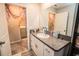 Well-lit bathroom features a granite vanity top with a sink and adjacent laundry area at 14430 English Lavender Dr, Wimauma, FL 33598
