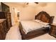 Classic bedroom with a carved wood bed frame, side tables, and carpeted flooring at 14430 English Lavender Dr, Wimauma, FL 33598