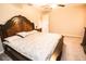 Bright bedroom with a carved wood bed frame, side tables, and carpeted flooring at 14430 English Lavender Dr, Wimauma, FL 33598