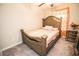 Cozy bedroom with a detailed wooden bed frame, a ceiling fan, and soft natural light at 14430 English Lavender Dr, Wimauma, FL 33598