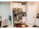 Kitchen featuring stainless steel refrigerator, white cabinets, granite countertops, and decorative accents at 14430 English Lavender Dr, Wimauma, FL 33598