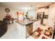 Bright kitchen with stainless steel appliances, a granite island, and an adjacent dining area with elegant decor at 14430 English Lavender Dr, Wimauma, FL 33598