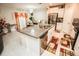 Bright kitchen boasts a large granite island, stainless steel appliances, and a dining area with elegant decor at 14430 English Lavender Dr, Wimauma, FL 33598