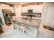 Modern kitchen with a granite island, white cabinetry, stainless steel appliances, and a stylish backsplash at 14430 English Lavender Dr, Wimauma, FL 33598