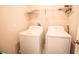 Laundry area featuring a white washer and dryer at 14430 English Lavender Dr, Wimauma, FL 33598