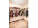 Walk-in closet featuring ample storage space, hanging racks, and carpeted flooring at 14430 English Lavender Dr, Wimauma, FL 33598