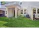 Spacious backyard featuring a covered patio area, lush green lawn, and a well-maintained exterior at 15033 Abby Birch Pl, Tampa, FL 33613