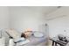 Minimalist bedroom with a neutral color palette, gray bedding, and sliding closet doors at 15033 Abby Birch Pl, Tampa, FL 33613