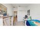 Cozy bedroom with a gamer chair, large dresser, and view into the hallway at 15033 Abby Birch Pl, Tampa, FL 33613