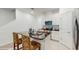 Bright kitchen with white cabinets, stainless steel appliances, and dark granite countertops at 15033 Abby Birch Pl, Tampa, FL 33613