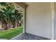 Covered patio offers a private outdoor space overlooking a lush green lawn and mature landscaping at 15033 Abby Birch Pl, Tampa, FL 33613