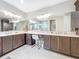 Large bathroom with double sinks, vanity, and tile flooring that creates a luxurious and functional space at 15434 Santa Pola Dr, Wimauma, FL 33598