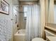 Neat bathroom featuring a shower-tub combo, vanity with cabinet, and decorative mirror at 15434 Santa Pola Dr, Wimauma, FL 33598