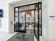 An open doorway to the Bistro Del Sol showcases inviting dining ambiance and stylish lighting at 15434 Santa Pola Dr, Wimauma, FL 33598