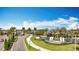 Scenic community entrance with lush landscaping and decorative waterfall feature at Valencia Del Sol at 15434 Santa Pola Dr, Wimauma, FL 33598