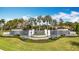 Valencia Del Sol entrance with decorative cascading waterfall feature, lush landscaping, and signage at 15434 Santa Pola Dr, Wimauma, FL 33598