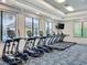 The fitness center is equipped with treadmills and elliptical machines with large windows at 15434 Santa Pola Dr, Wimauma, FL 33598