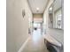 Spacious hallway with tile floors connecting the entryway to the main living areas at 15434 Santa Pola Dr, Wimauma, FL 33598