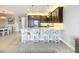 Stylish kitchen features a center island with seating and stainless steel appliances at 15434 Santa Pola Dr, Wimauma, FL 33598