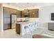 Modern kitchen with island seating and stainless steel appliances at 15434 Santa Pola Dr, Wimauma, FL 33598