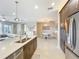Bright kitchen features granite counters, stainless steel appliances, and an open floor plan at 15434 Santa Pola Dr, Wimauma, FL 33598