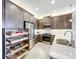 Beautiful kitchen featuring pull-out shelving, stainless steel appliances, and granite countertops at 15434 Santa Pola Dr, Wimauma, FL 33598