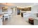 Open concept kitchen with stainless steel appliances, a center island with seating, and modern dark-stained cabinetry at 15434 Santa Pola Dr, Wimauma, FL 33598