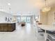 Open-concept living space features tile floors and a seamless transition to the outdoor lanai at 15434 Santa Pola Dr, Wimauma, FL 33598