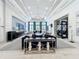 A stylish lobby area with comfortable seating, elegant decor, and ample natural light. Bistro entrance visible at 15434 Santa Pola Dr, Wimauma, FL 33598