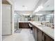 Modern main bathroom featuring double sinks, a large mirror, and a glass-enclosed shower for a luxurious feel at 15434 Santa Pola Dr, Wimauma, FL 33598