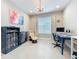 Bright home office setup featuring a desk, chair, bookshelf, and recliner, perfect for work and relaxation at 15434 Santa Pola Dr, Wimauma, FL 33598