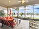 Enclosed patio boasting comfortable seating, ceiling fan, and scenic water view at 15434 Santa Pola Dr, Wimauma, FL 33598